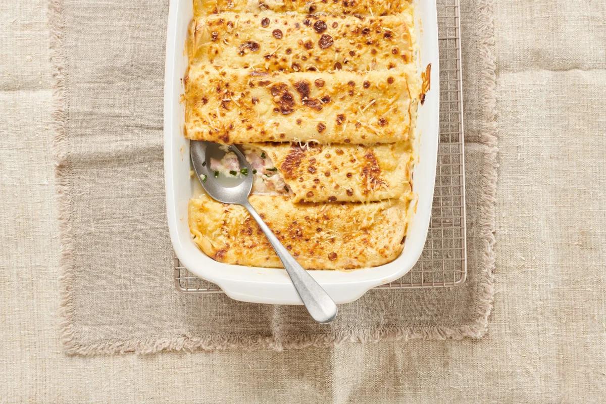 Crêpes gratinées de la catégorie . Méthode de préparation pâte à crêpes ou à knöpfli. Le plat terminé est joliment présenté et photographié en vue aérienne (photographie alimentaire). Suggestion de présentation, recette originale de Croqu'menus, tirée du livre de cuisine le plus connu de Suisse